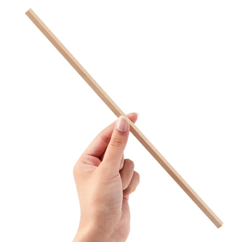 Hand holding a square wood dowel, quarter inch by 12 inch, from the 25 pack unfinished craft sticks for crafts.