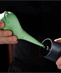 Person using Dope Bird Inspired Coffee Air Blower Air Duster For Espresso Machines And Delicate Electronics Like Watches Cameras Keyboards And Sensors Removable Pump Cleaning Tool In White to clean a coffee grinder