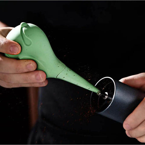 Person using Dope Bird Inspired Coffee Air Blower Air Duster For Espresso Machines And Delicate Electronics Like Watches Cameras Keyboards And Sensors Removable Pump Cleaning Tool In White to clean a coffee grinder