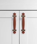 Vintage Leather Trunk Handle Replacement For Cabinets And Drawers Brown Leather Cabinet Pulls installed on white doors