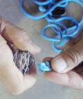 Hands splicing blue synthetic rope using Fast Fid Rope Splicing Tool For Quick Synthetic Winch Line Repairs, Compact Billet Aluminum Splice Aid.