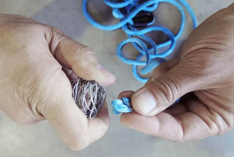 Hands splicing blue synthetic rope using Fast Fid Rope Splicing Tool For Quick Synthetic Winch Line Repairs, Compact Billet Aluminum Splice Aid.