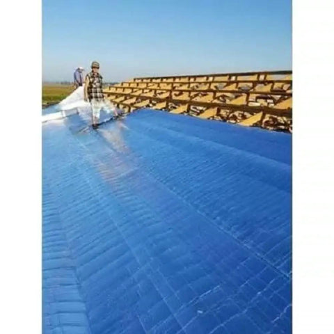 Workers installing Four By Two Hundred Fifty Foot Synthetic Roof Underlayment Pro Grade Heavy Slick Roll on a roof.