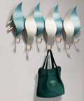 Heavy Duty Wall Mounted Coat Hook With Snowflake Design Iron Wall Hook For Entryway And Bathroom Rust Resistant Metal Hanger For Scarves Umbrellas Bags Keys And Hats Single Unit Silver Finish Home Decor Space Saver displaying a green bag.
