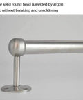 Close-up of heavy duty stainless steel clothes rod for modern closets with welded round head and wall mount