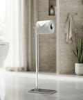 Freestanding Toilet Paper Holder Stand With Weighted Base In Modern Rectangle Chrome Finish For Bathroom Vanity A Must Have Upgrade You Can Move Anytime Grab And Go No Wall Mount Needed Sleek Contemporary Design in bathroom setting.