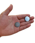 Two Slick Nickel Coated Steel Discs 0.98 Inch Diameter held in hand, showcasing smooth chamfered edges and nickel finish.