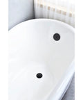 Brass Bathtub Drain Kit With Lift And Turn Mechanism, Single Hole Overflow Faceplate, Matte Black Finish in a white tub