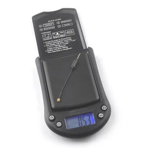 3 Pack 5.8G 2dBi Dipole UFL Omni FPV Antenna on digital scale showing 1.53g weight, RG113 cable, compact design for racing drones.