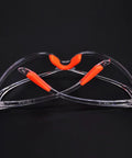 Rugged 4 Piece Set Of Anti Fog Safety Glasses Featuring Rock Solid Polycarbonate Shields And Soft Silicone Gaskets For Heavy Duty Workshop Protection Clear Impact Resistant Eyewear For Pros And Crew with orange accents.