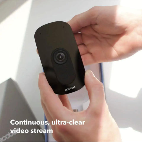 Person holding SmartCamera from Home Security Bundle With 1080P HDR Smart Doorbell Camera Wired SmartSensor For Doors And Windows And SmartCamera With Voice Control For A Connected Easy To Use Home Safety System.