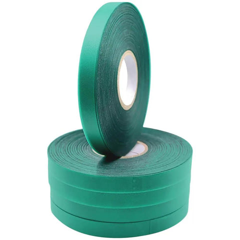 Four green plant tie tape rolls 6 mil thick half inch wide 200 feet each, stacked for large tapeners and tie guns, securing vines and trees.