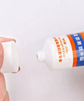 Close-up of Quick Dry Wall Patch Kit tube being opened, showing the tip for applying easy wall filler paste.