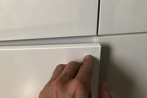 Set Of Three Push To Open Cabinet Latches With Silent Magnetic Catch For Dead Simple Drawer Opens Light Finger Tap Action Silver Kitchen Hardware Upgrade showing a hand gently pressing a cabinet door.