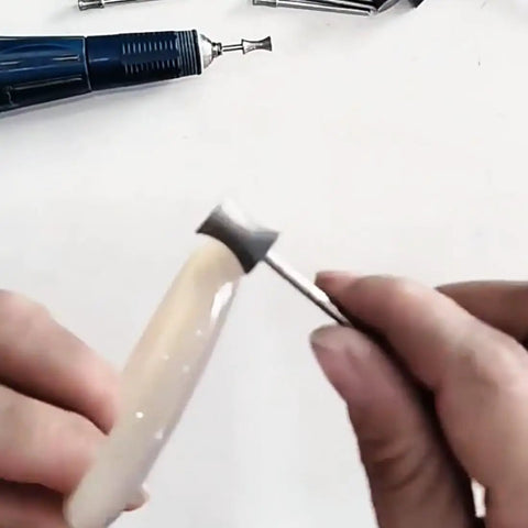 Person using Six Piece Concave Arc Diamond Burr Set Coarse Grit Diamond Mounted Grinding Bits for jewelry making with rotary tool.