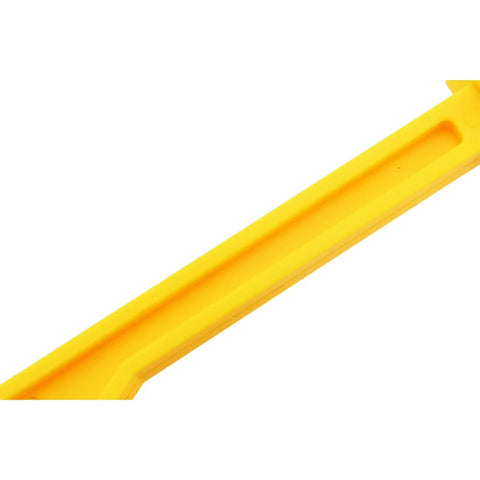 Close-up of bright yellow ergonomic woodworking push stick for table saws jigsaws and planers high visibility power tool accessory