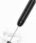 Rechargeable Milk Frother Handheld USB C Foam Maker With Detachable Stainless Steel Whisk in black, no stand, splashing milk