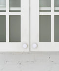 Front view of cabinets with Four Sizes White Plastic Hole Plugs For Cabinet And Furniture Round End Caps For Screw Holes installed