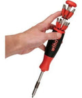 Hand holding Ultra Handy 26-In-1 Industrial Screwdriver Kit with red handle and multiple bits visible