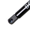 Close-up of a black gas strut end, part of 2 Pack Rear Trunk Lift Supports For Chrysler Sebring 1996 1997.