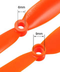 Close-up of Orange 8 By 6 Inch RC Propellers Two Vane Fixed Wing For Airplanes Nylon Durable With Adapter Rings showing 6mm and 9mm holes.
