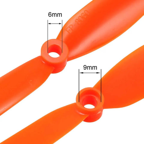 Close-up of Orange 8 By 6 Inch RC Propellers Two Vane Fixed Wing For Airplanes Nylon Durable With Adapter Rings showing 6mm and 9mm holes.