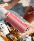 Chill Vibes While Crushing A Cold Brew With This Stainless Steel Skinny Can Cooler Fits All 12 Oz Slim Cans Features Double Walled Insulation being used at the beach.