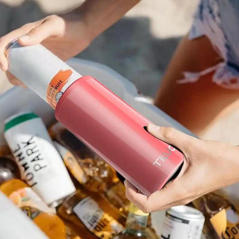 Chill Vibes While Crushing A Cold Brew With This Stainless Steel Skinny Can Cooler Fits All 12 Oz Slim Cans Features Double Walled Insulation being used at the beach.