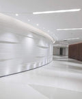 Sorfia 10pcs 2 inch Gimbal LED Recessed Light Small Recessed Lights AC110V illuminating a modern curved corridor.