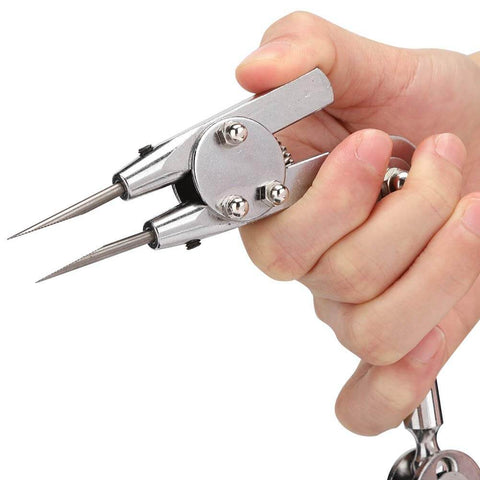 Close-up of hand holding adjustable third hand welding clip sturdy alloy steel soldering fixture clamp for small object repairs.