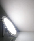 Illuminated 7 Inch 18W LED Recessed Ceiling Light Ultra Thin Downlight 6000K Daylight White Retrofit Kit on white surface