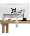 Heavy Duty Monitor Mount With Super Slick Cable Management And Hella Sturdy No Drill Clamp holding a monitor on a wooden desk.