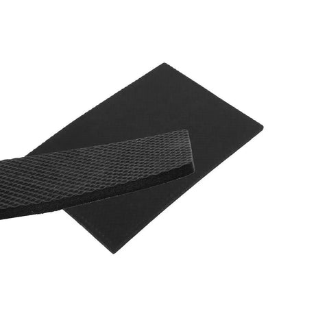 Close-up of textured Self Adhesive Rubber Floor Protector Pads For Furniture 4 Pack black foot pads showing thickness and texture.