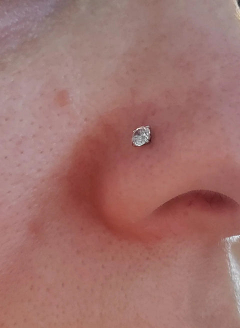 Close-up of a nose with a flat back earring, showcasing use of Threadless Piercing Tapers Set Go To For Changing And Insertion Tools 16G 18G 20G.