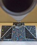 Front view of Saddle Support Rooftop Pipe Stand with a speckled recycled-plastic base and pipe cradle