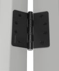 Black 4-inch ball bearing door hinge installed on a door with visible screws.