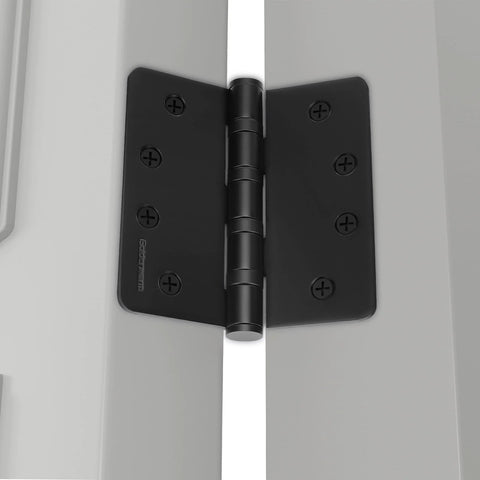 Black 4-inch ball bearing door hinge installed on a door with visible screws.