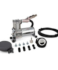 Compact Black Air Compressor Portable Grab And Go Tire Inflator with accessories displayed. Includes hose, adapters, and fittings.