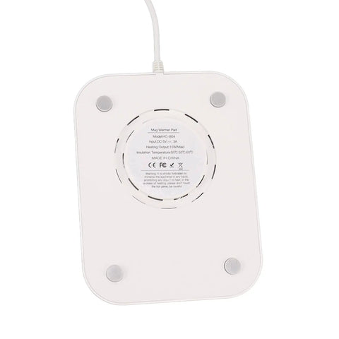 Kick Those Cold Coffee Sips To The Curb With This Electric Desk Mug Warmer featuring a white heating pad and four rubber feet.