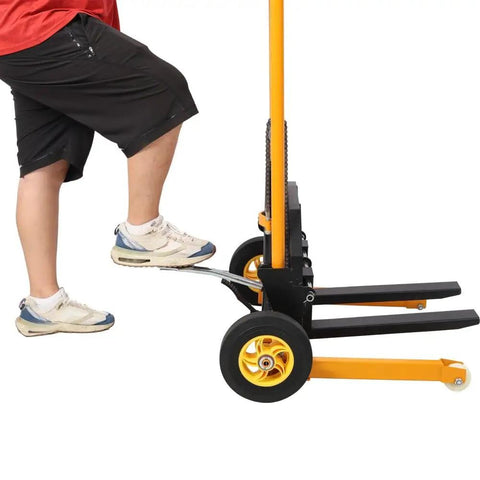 Close-up of a user operating the Straight Up Heavy Duty Manual Hydraulic Pallet Stacker with 440 lb load capacity at a warehouse.