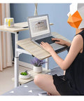 Hella Convenient Height Adjustable Overbed Table And Smooth Rolling Mobile Laptop Desk With Rock Solid Frame Sit To Stand Cart For Sofa Or Bed Side Ergonomic Computer Workstation For Home Office with laptop, plant, and mug.