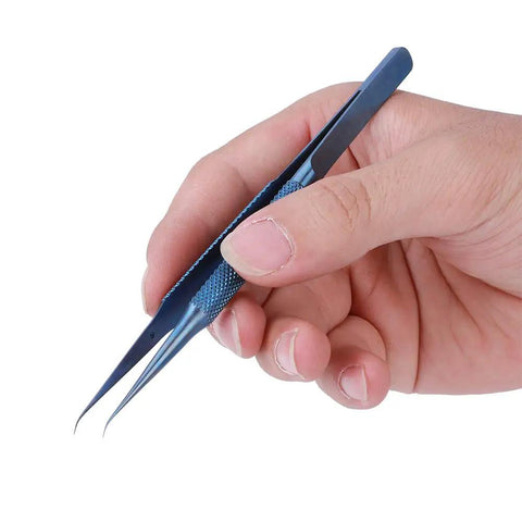 Ultra Fine 0.15mm Ti Alloy Tip For Phone Board Repair Soldering Bent Head Magnetic Tool held in hand, ideal for precise electronics repair.