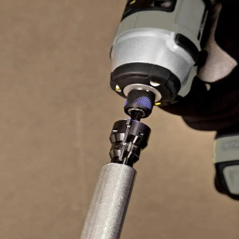 Power Conduit Reamer With Improved Bit Retention in use reaming one inch conduit, powered by a drill, showcasing hex bit storage.