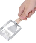 Sturdy Stainless Honeycomb Uncapper Fork With Wooden Handle in hand showing sharp tines for beekeeping.