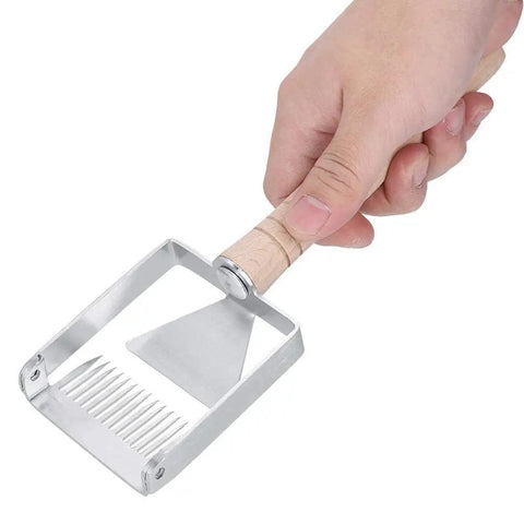 Sturdy Stainless Honeycomb Uncapper Fork With Wooden Handle in hand showing sharp tines for beekeeping.