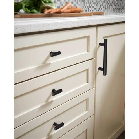 Hella Sleek Matte Black T Pull Cabinet Knobs 1.5 Inch horizontal handles on cream kitchen cabinets.