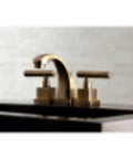 Claremont Mini Widespread Lavatory Faucet With Brass Pop Up Drain Polished Brass Finish installed on black countertop