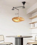 Chandelier Adjustable Hanging Light Fixtures, Modern Swing Arm Pendant,1 Long for Dining Room Kitchen Island Matte Black Finish(23.6in) above a table.