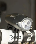 Beamer 3 Bike Headlight With Nichia LEDs Long Run Time Up To 100 Hours 220 Degree Visibility mounted on bicycle handlebars.