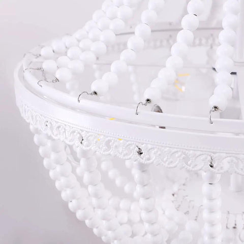 Close-up of white wood bead detail on Wood Bead Chandelier Light Fixture In White Finish Farmhouse Bohemian 4 Light Empire Pendant.